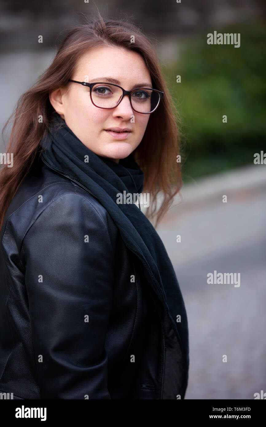 portrait young brunette woman in leather jacket standing outside Stock ...