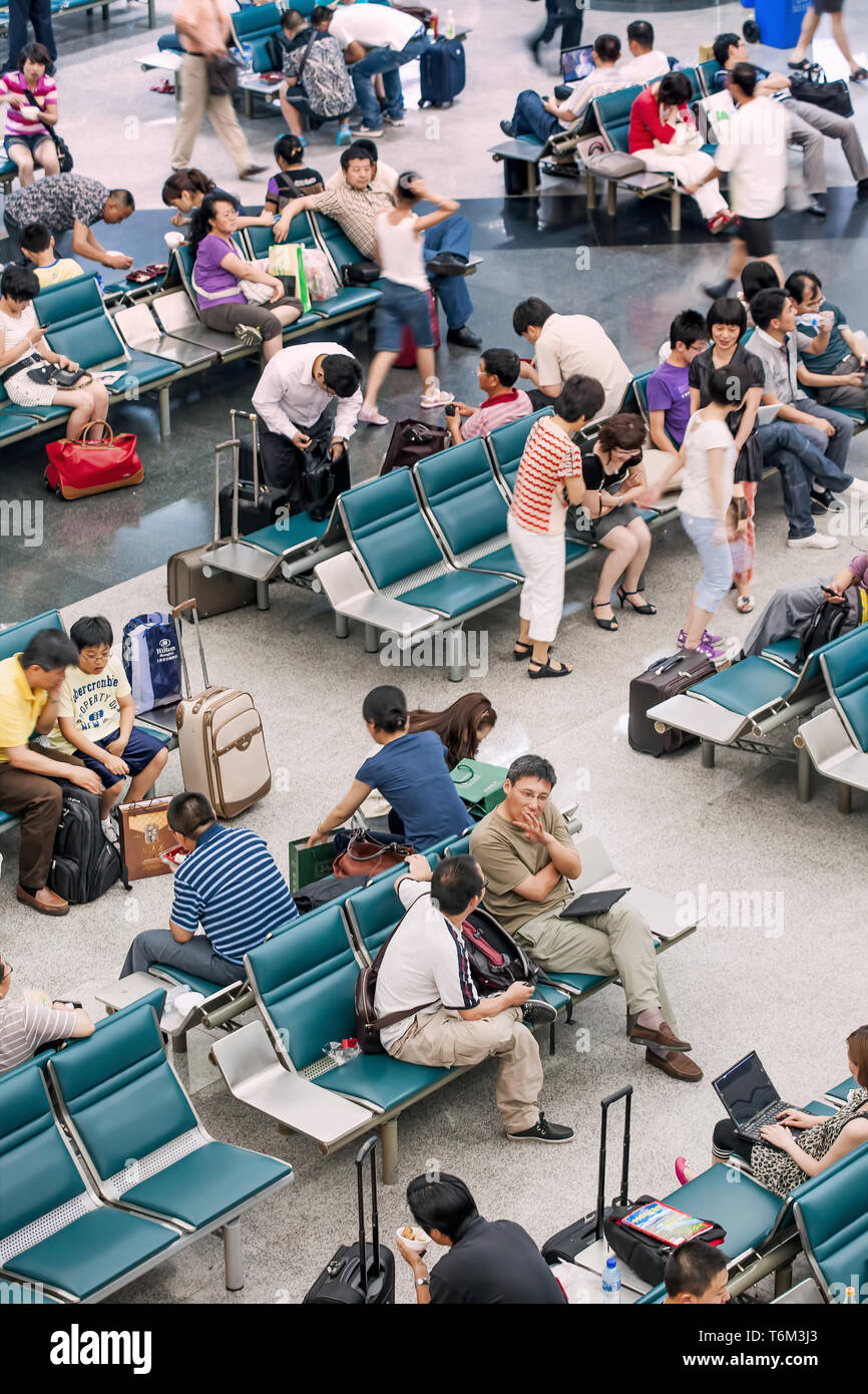 Crowd in departure hall. China is spearheading Asian air travel boom and is set to overtake the US as the world’s largest aviation market in 2030. Stock Photo