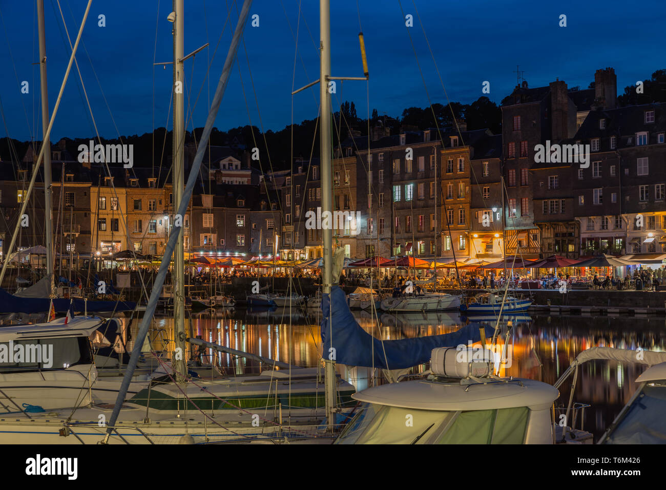Harbor Honfleur at night with ships and restaurants, France Stock Photo ...