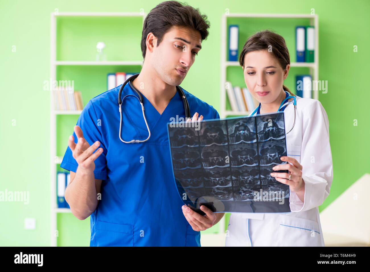 Woman and man gynecologists discussing medical case at the clini Stock