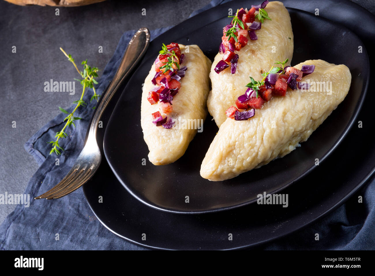 Rustic Cepelinai, a specialty Lithuanian and Polish cuisine. Stock Photo