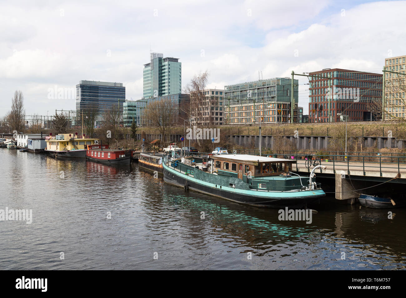 City of Amsterdam with office buildings and houseboats Stock Photo