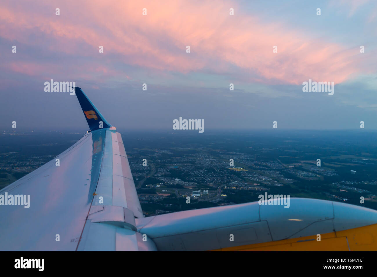 Dulles, USA - June 13, 2018: Icelandair airplane in sky from window high angle view over Atlantic Arctic ocean during sunset plane wing by airport in  Stock Photo