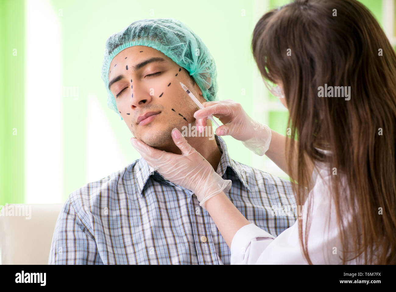 Plastic surgeon preparing for operation on man face Stock Photo - Alamy