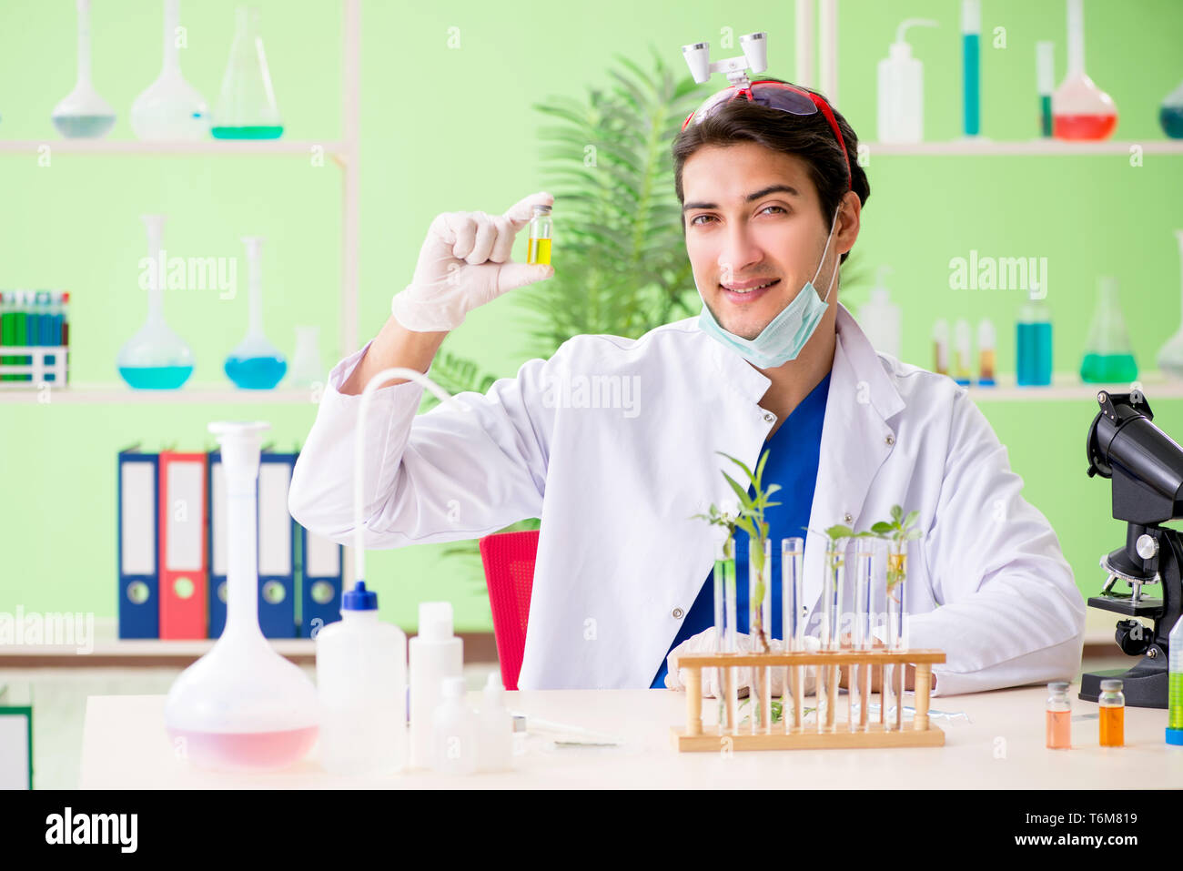 Young biotechnology scientist chemist working in lab Stock Photo