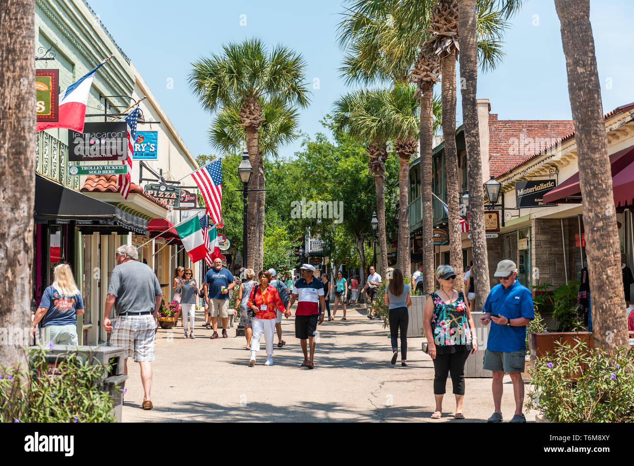 St. Augustine, USA - May 10, 2018: St George Street and people walking during day by colorful restaurants and stores in downtown old town Florida city Stock Photo