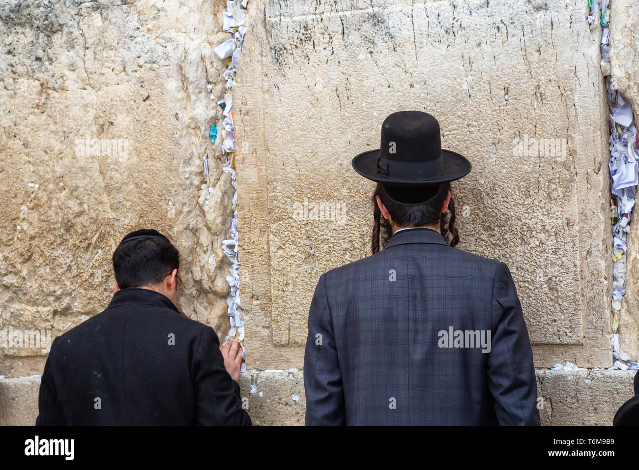 Religious Man, Hasidic Jew, dressed in black is praying by the Western Wall in the Old City. Taken in Jerusalem, Israel. Stock Photo
