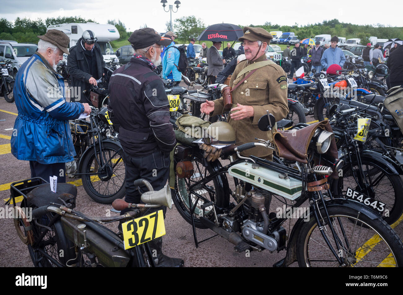 A man dressed in First World War uniform by his classic period Triumph motorcycle at the Banbury Run. Stock Photo