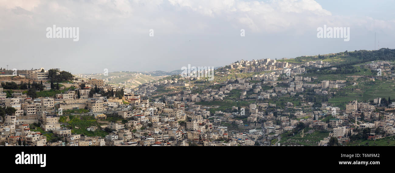 Aerial panoramic cityscape view of Jabal Batin alHawa residential neighborhood during a cloudy day. Taken in Jerusalem, Israel. Stock Photo