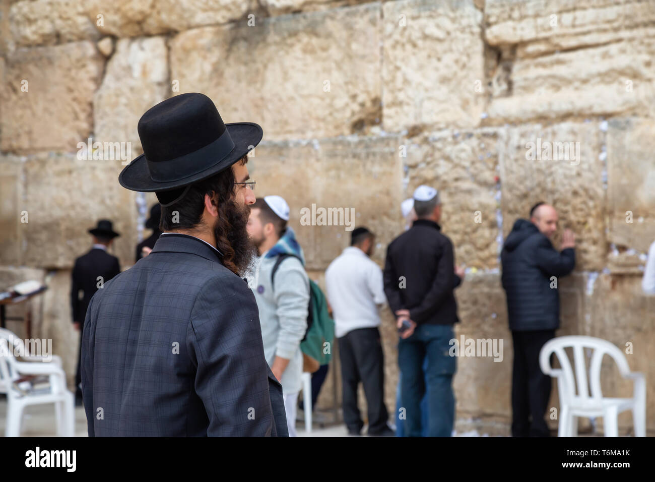 Jerusalem, Israel - April 2, 2019: Religious Man, Hasidic Jew, dressed in black is praying by the Western Wall in the Old City. Stock Photo