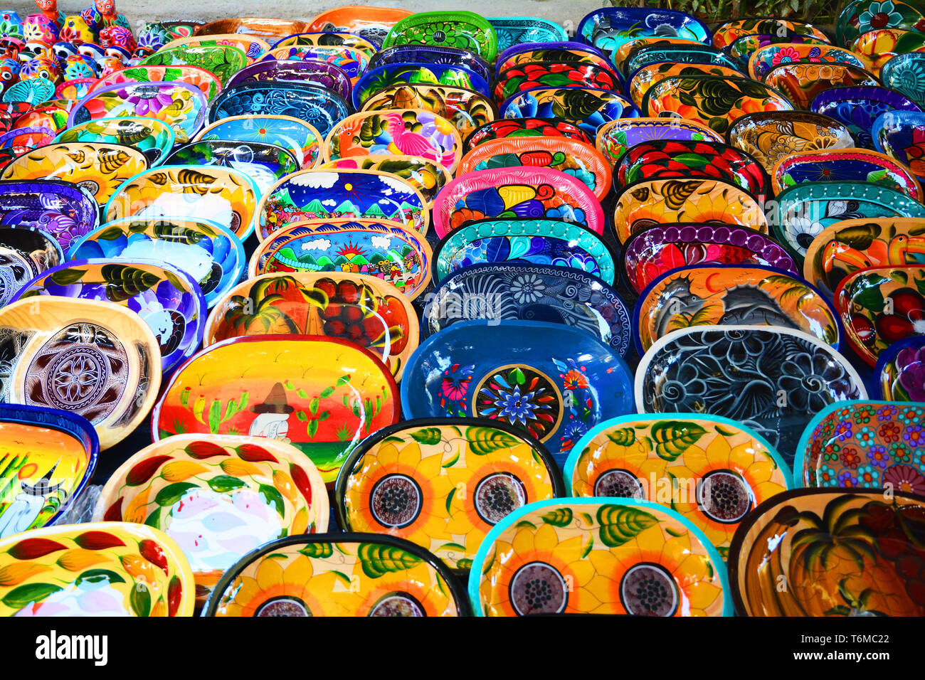Hand made/painted colorful Mexican plates with designs on display Stock