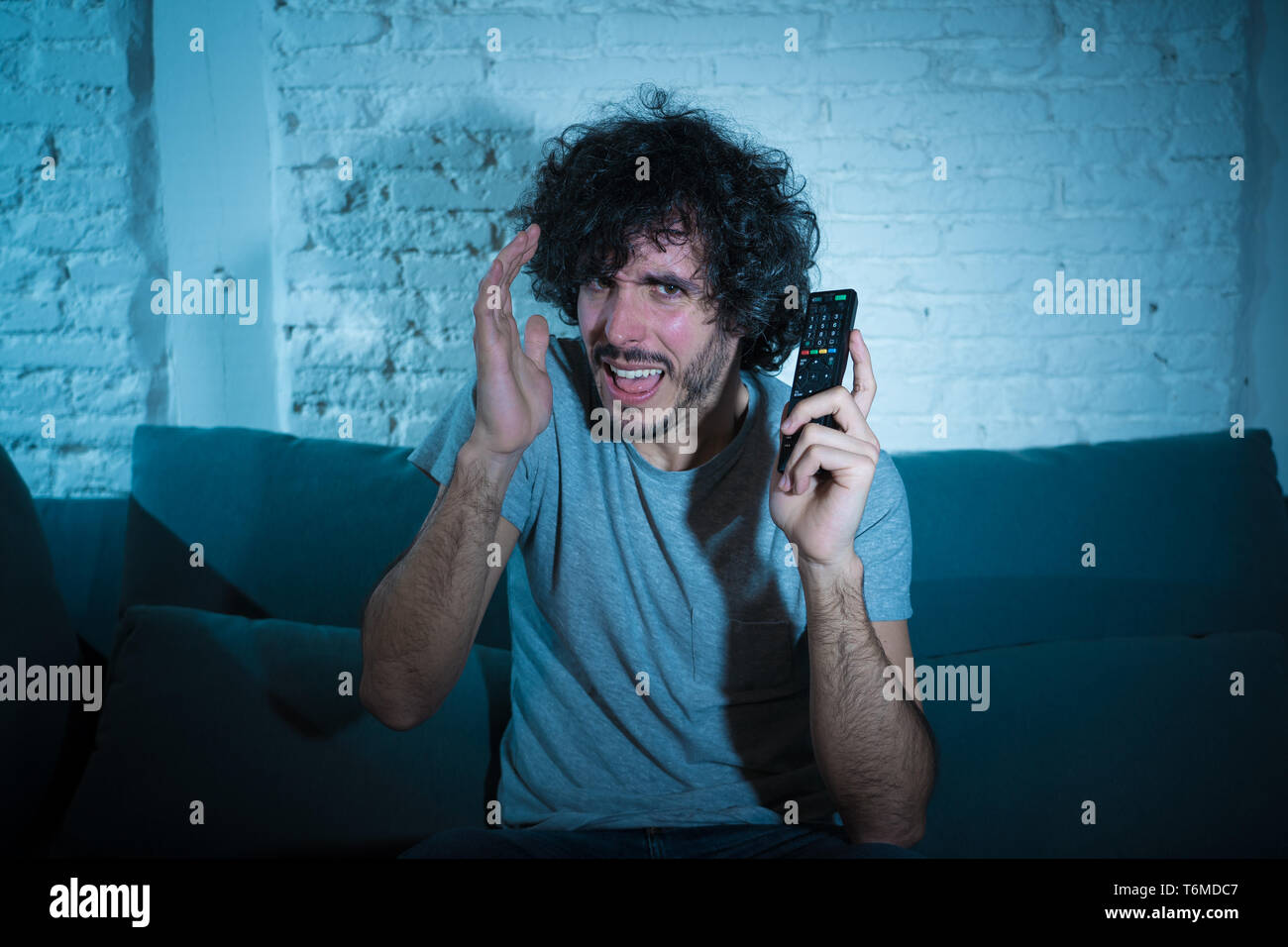 Lifestyle portrait of young man feeling scared and shocked making fear