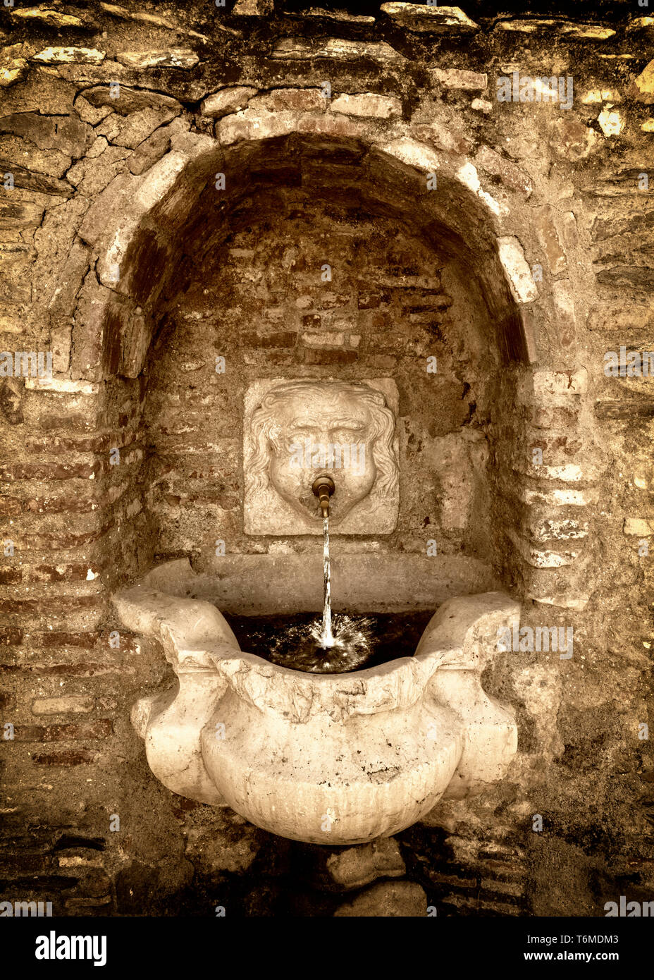 An old drinking fountain in the main street of Macharaviaya, a municipality in the province of Málaga in the mountains of the autonomous community of  Stock Photo