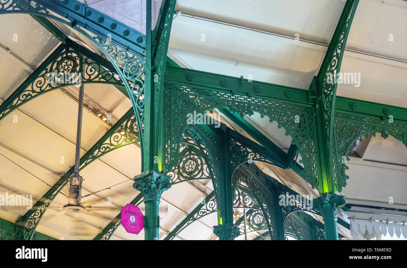 Green painted cast iron latticework and fretwork of the trusses, archways, eaves brackets at Lau Pa Sat Hawker Food markets in downtown Singapore. Stock Photo
