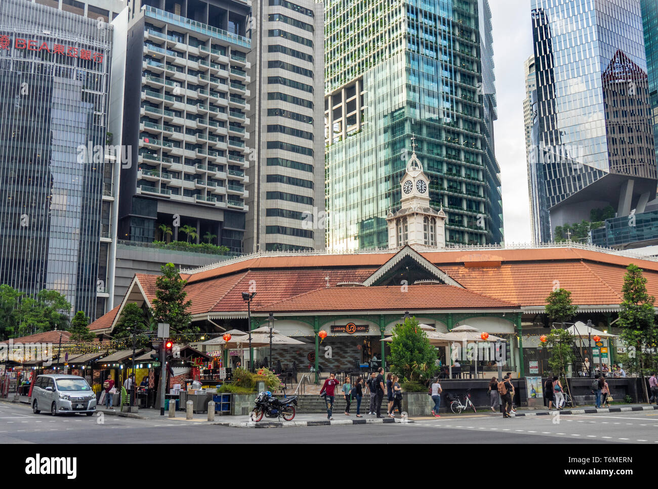 Office and residential towers skyscrapers towering over Lau Pa Sat hawker food markets in downtown Singapore. Stock Photo