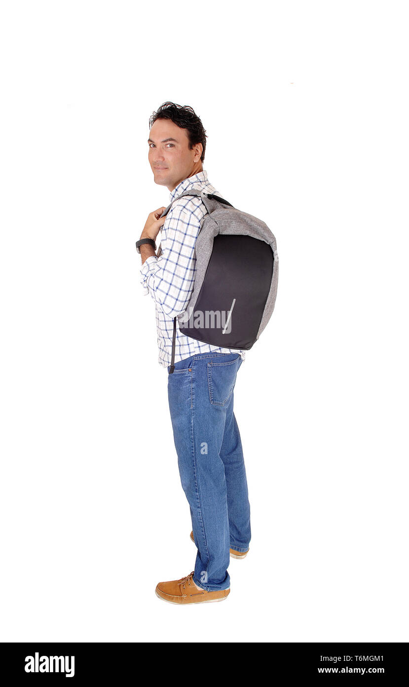 Young man standing in profile with his backpack Stock Photo