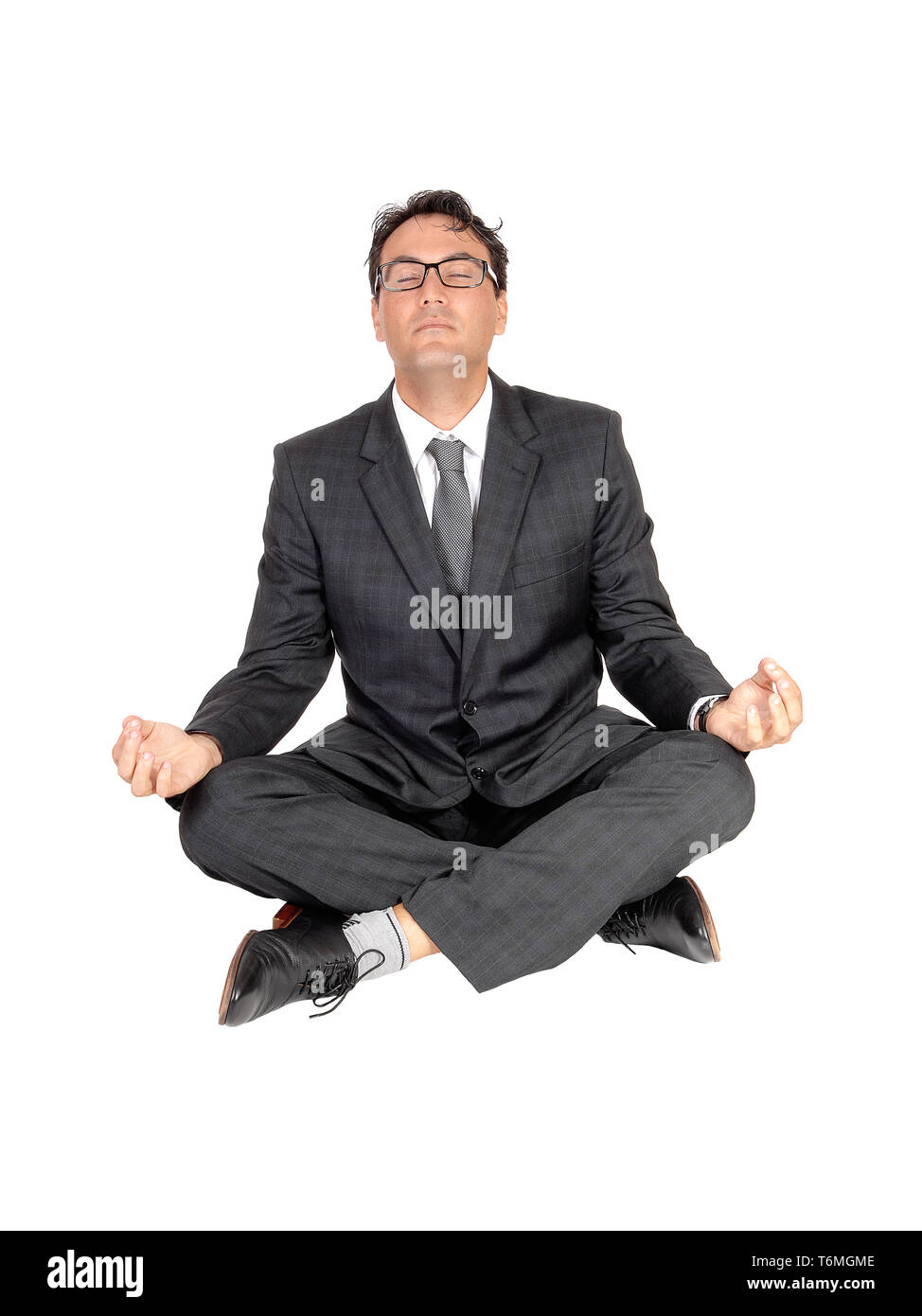 Man sitting on floor meditating hi-res stock photography and images - Alamy