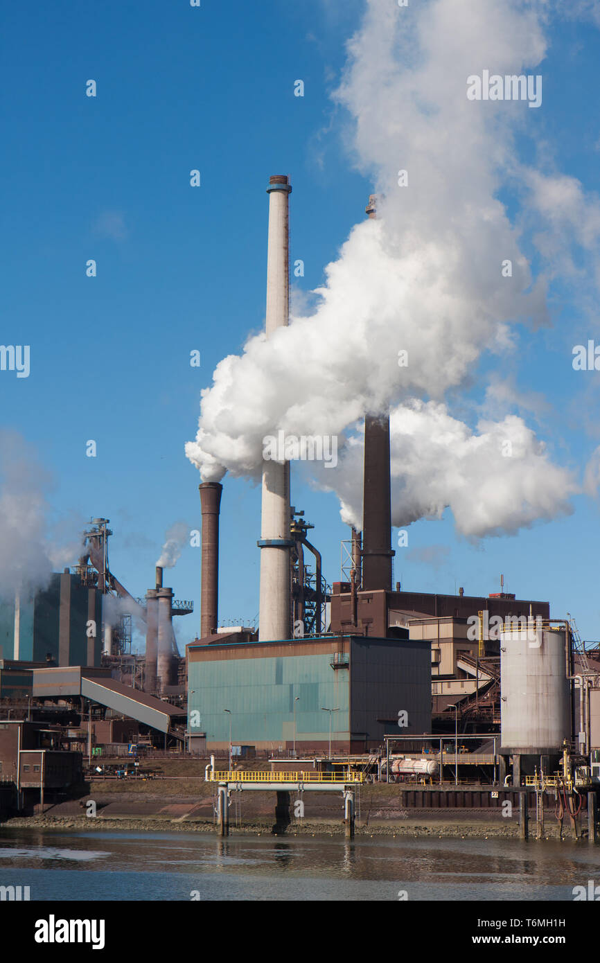 Steel factory with big chimneys in IJmuiden, the Netherlands Stock Photo