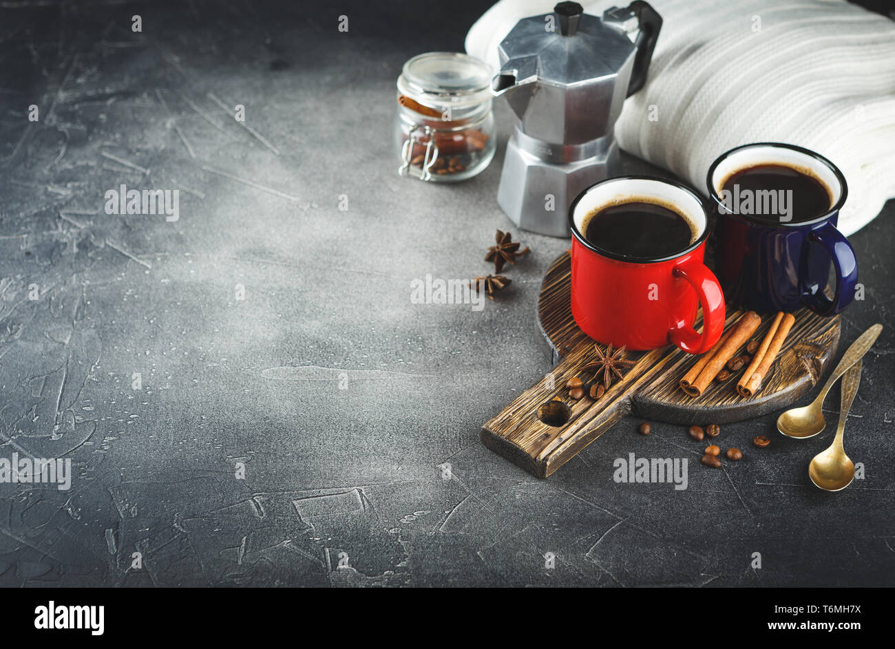 Winter coffee with spices in color enamelled cups Stock Photo