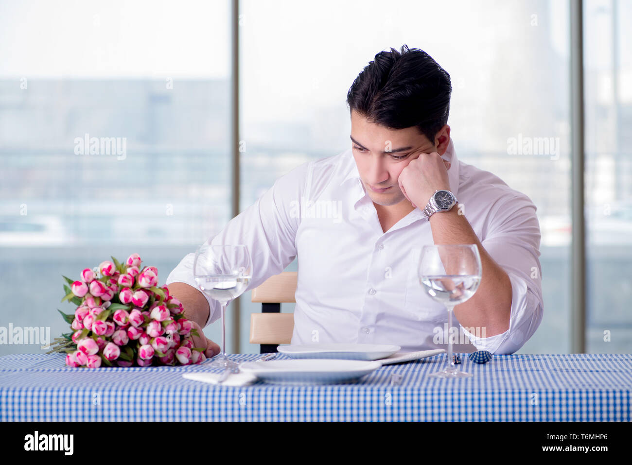 Handsome man alone in restaraunt on date Stock Photo