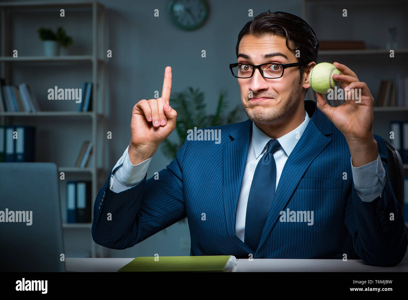 Young employee with tennis ball Stock Photo Alamy