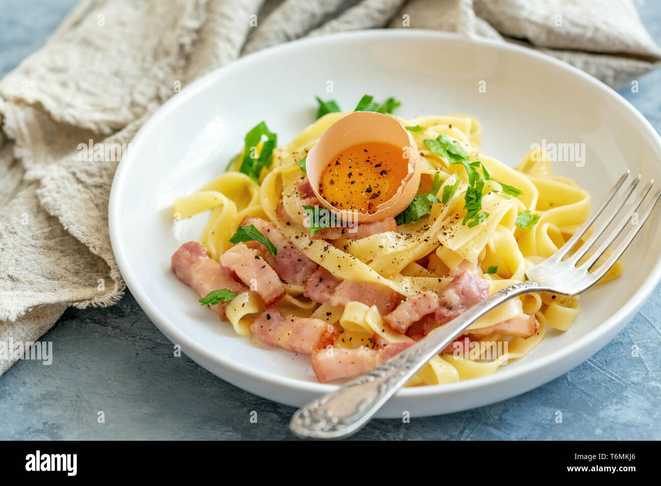 Pasta carbonara with egg yolk in a white plate Stock Photo Alamy