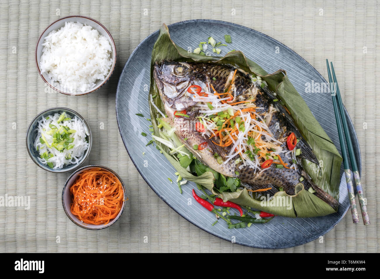 Traditional Thai barbecue tilapia fish with chili and vegetable as top