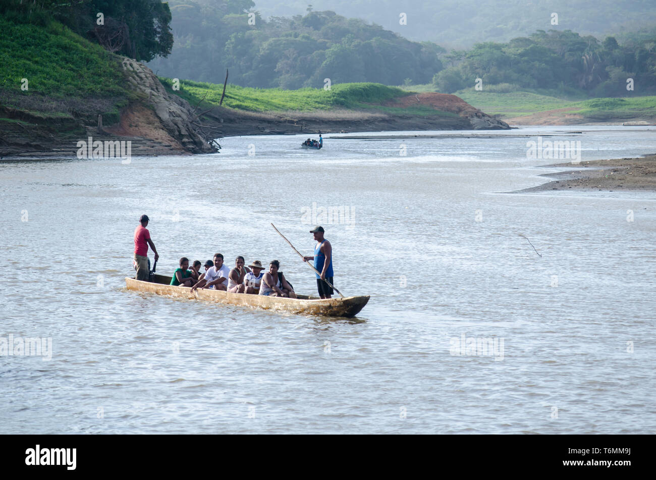 People navitating Lake Alajuela in a dugout canoe Stock Photo