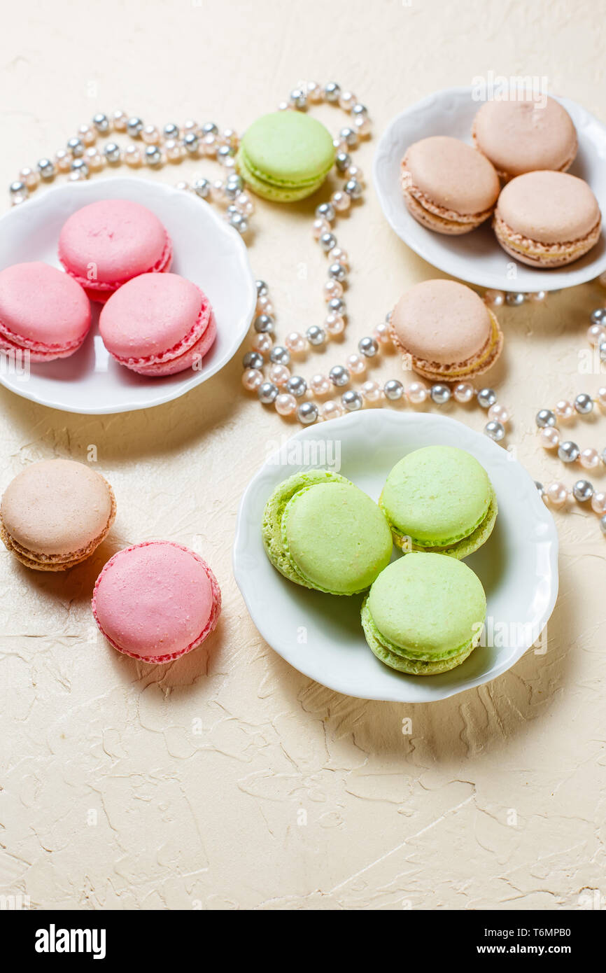 Colourful macaroons on the plates Stock Photo