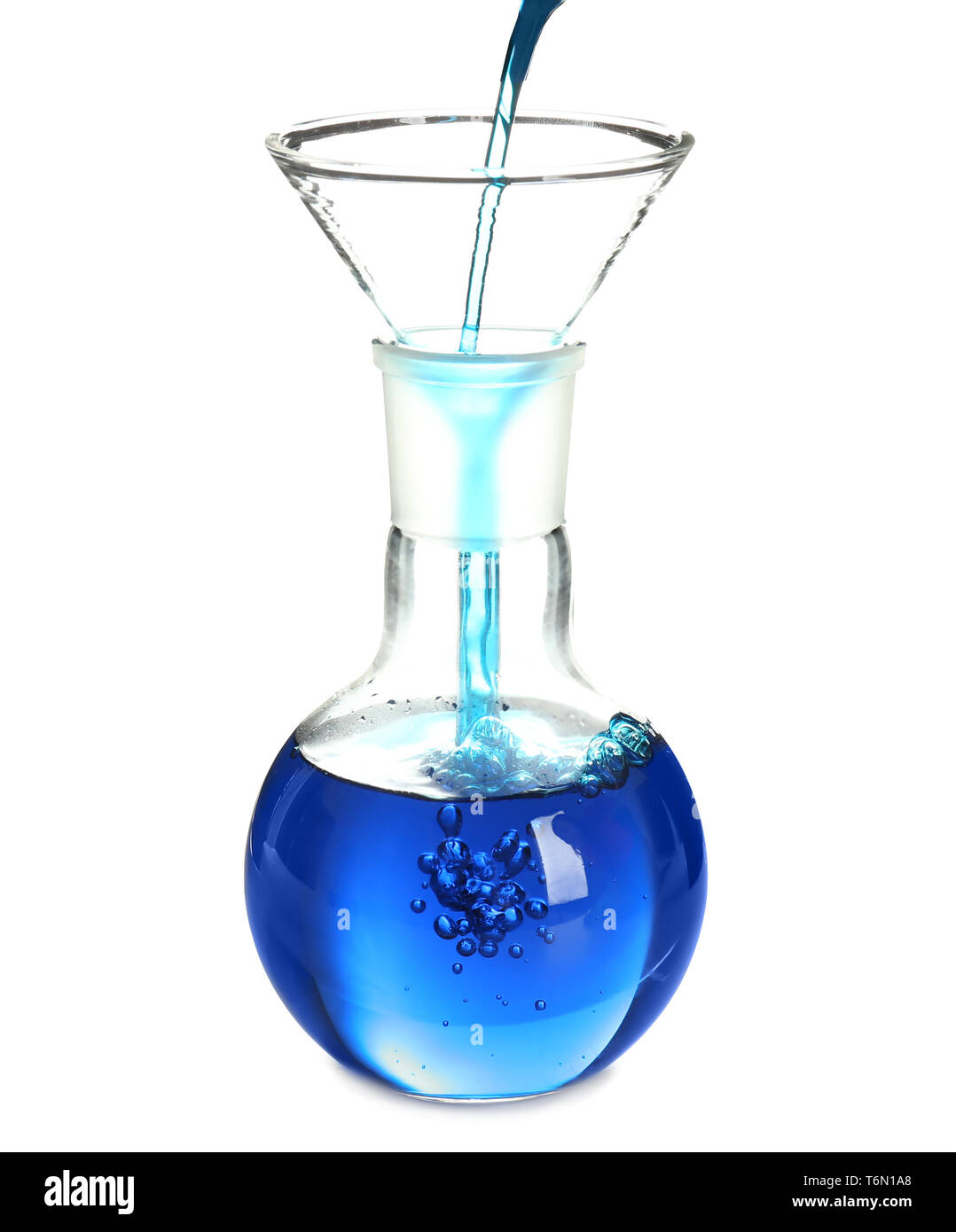 Pouring blue liquid through filter funnel into flask on white