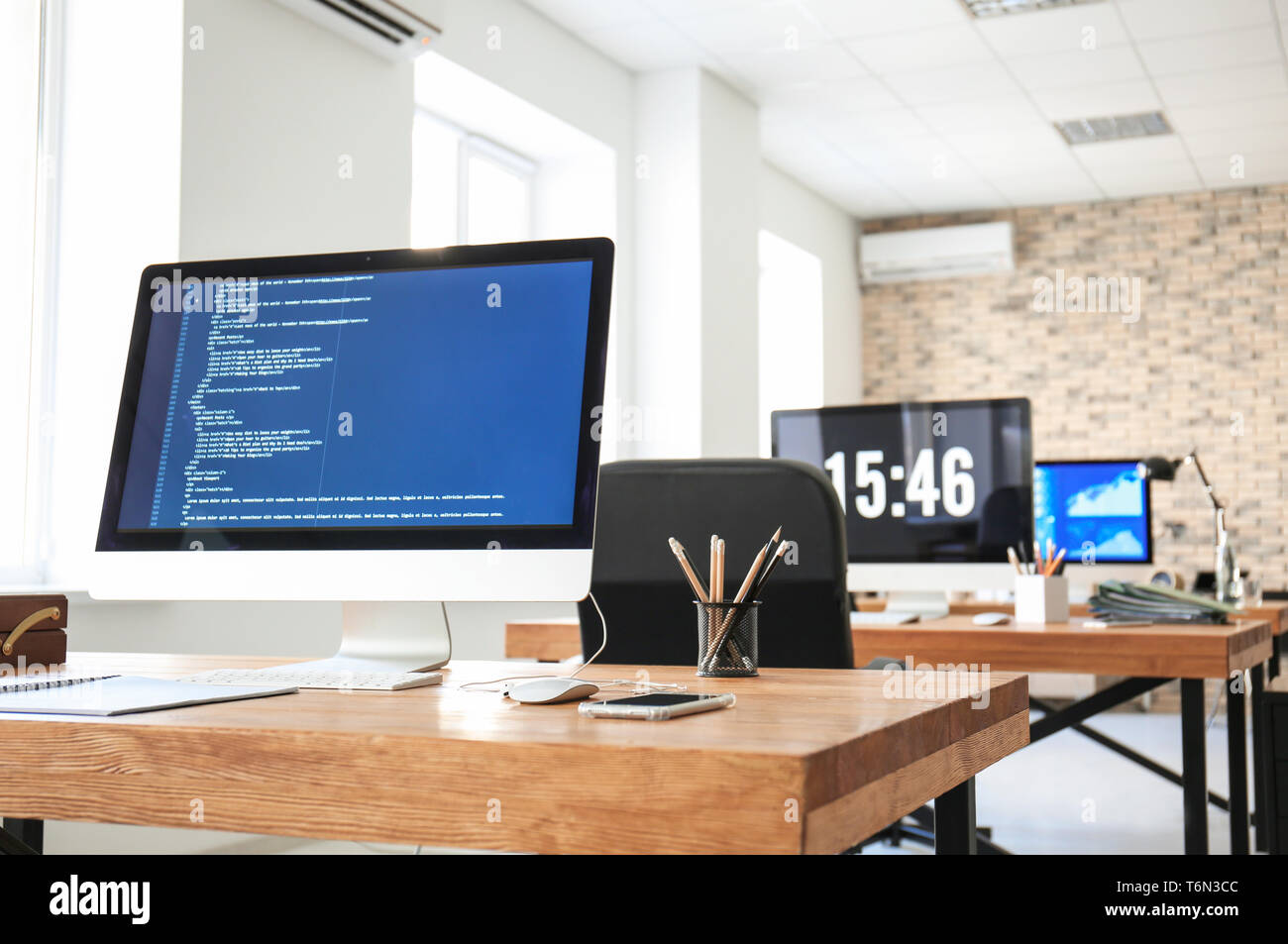Office interior with computers and tables. Workplace design Stock Photo