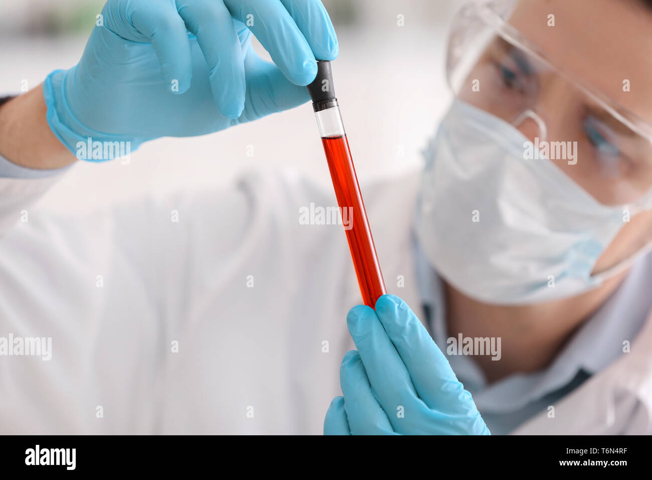 Scientist holding test tube with color sample in laboratory Stock Photo ...