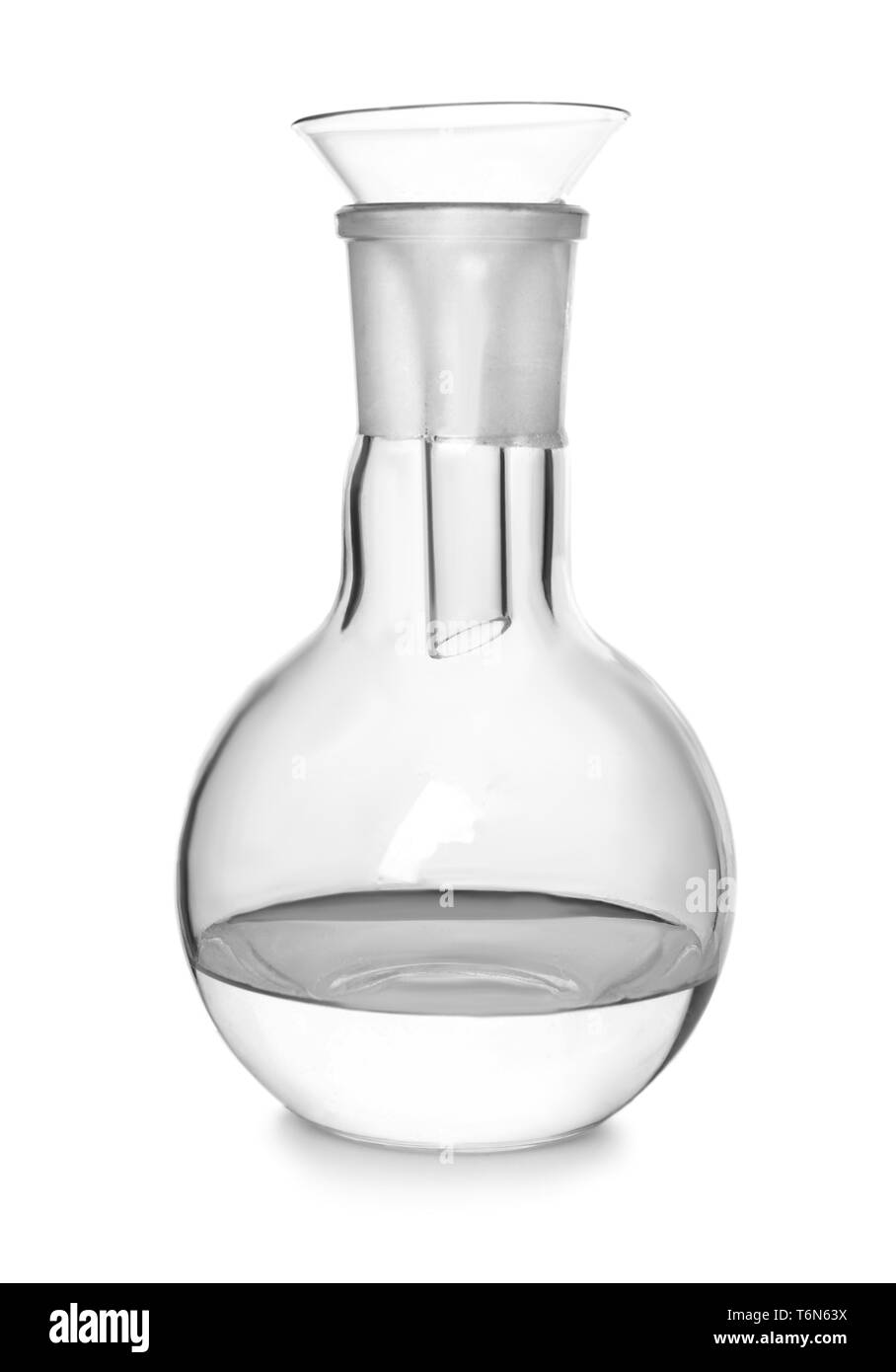 Volumetric flask with liquid and filter funnel on white background Stock Photo