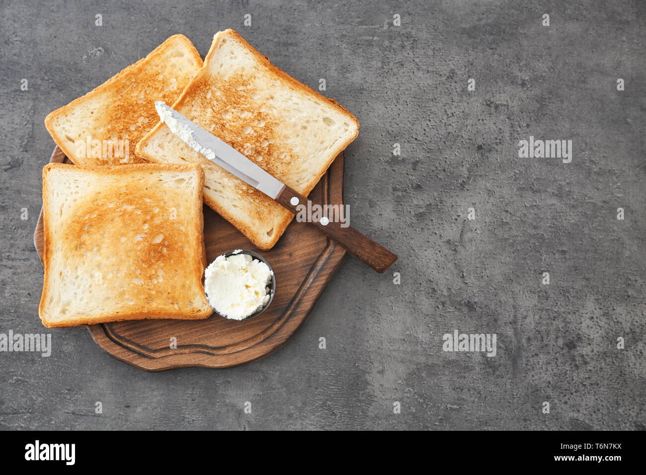 Toasted bread with cream cheese on wooden board Stock Photo - Alamy
