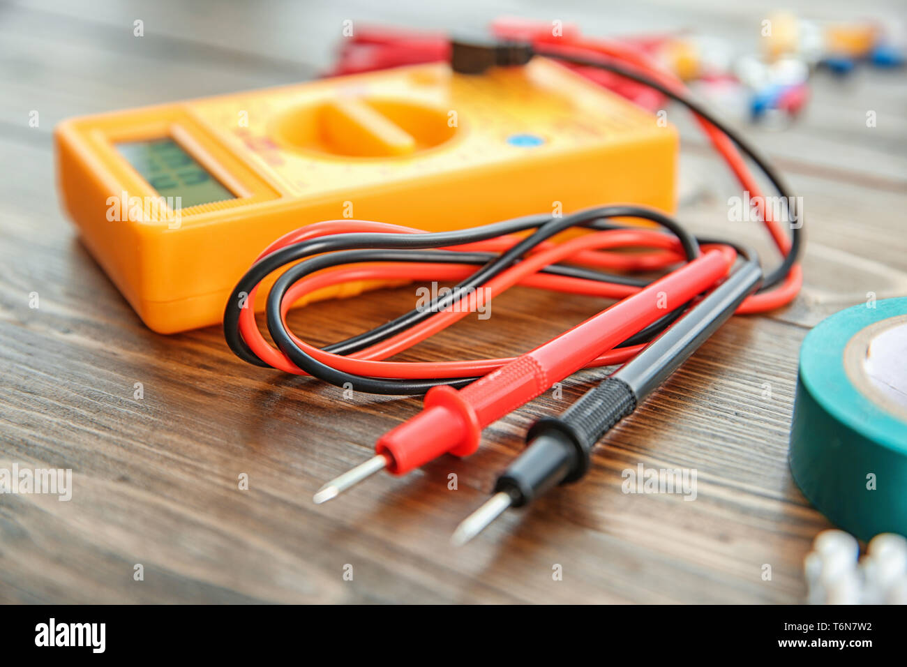 Multimeter on wooden table. Electrical tools Stock Photo