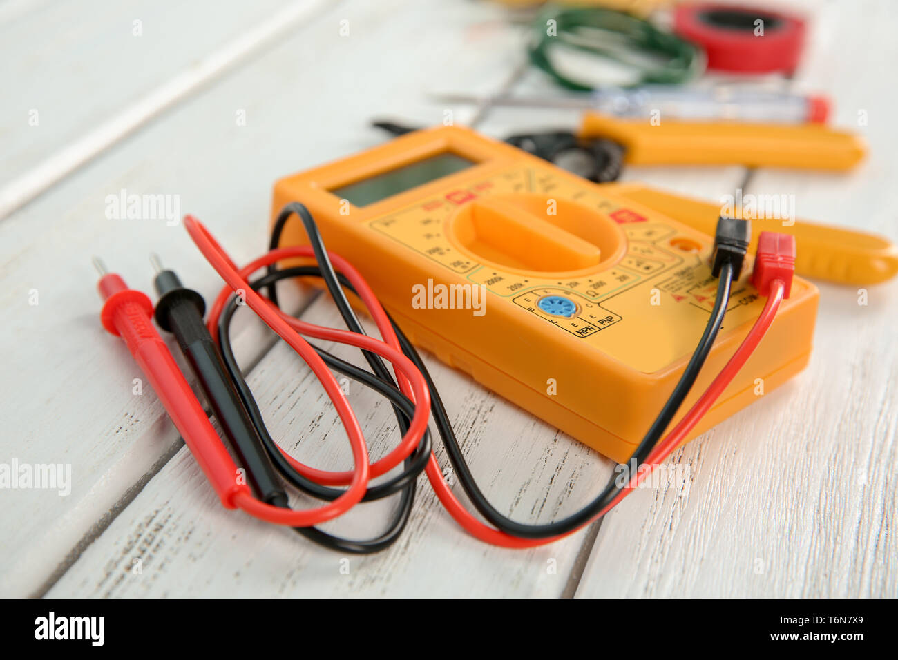 Multimeter on wooden table. Electrical tools Stock Photo