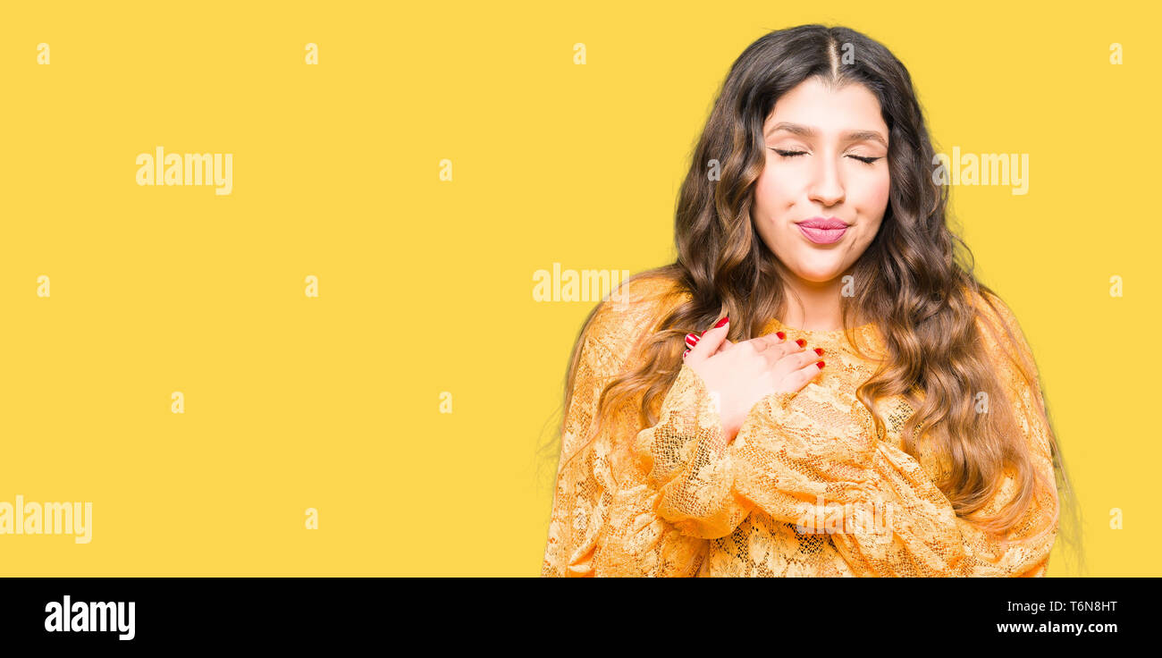 Young beautiful woman wearing yellow elegant dress smiling with hands ...