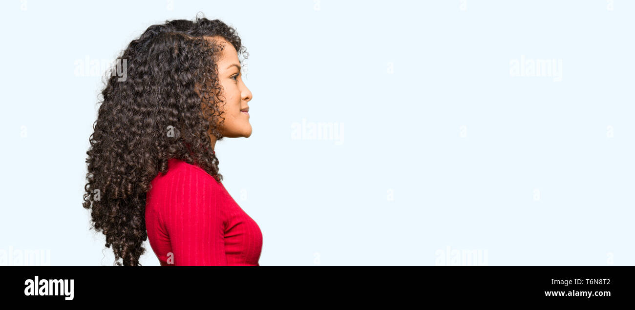Young Beautiful Woman With Curly Hair Looking To Side Relax
