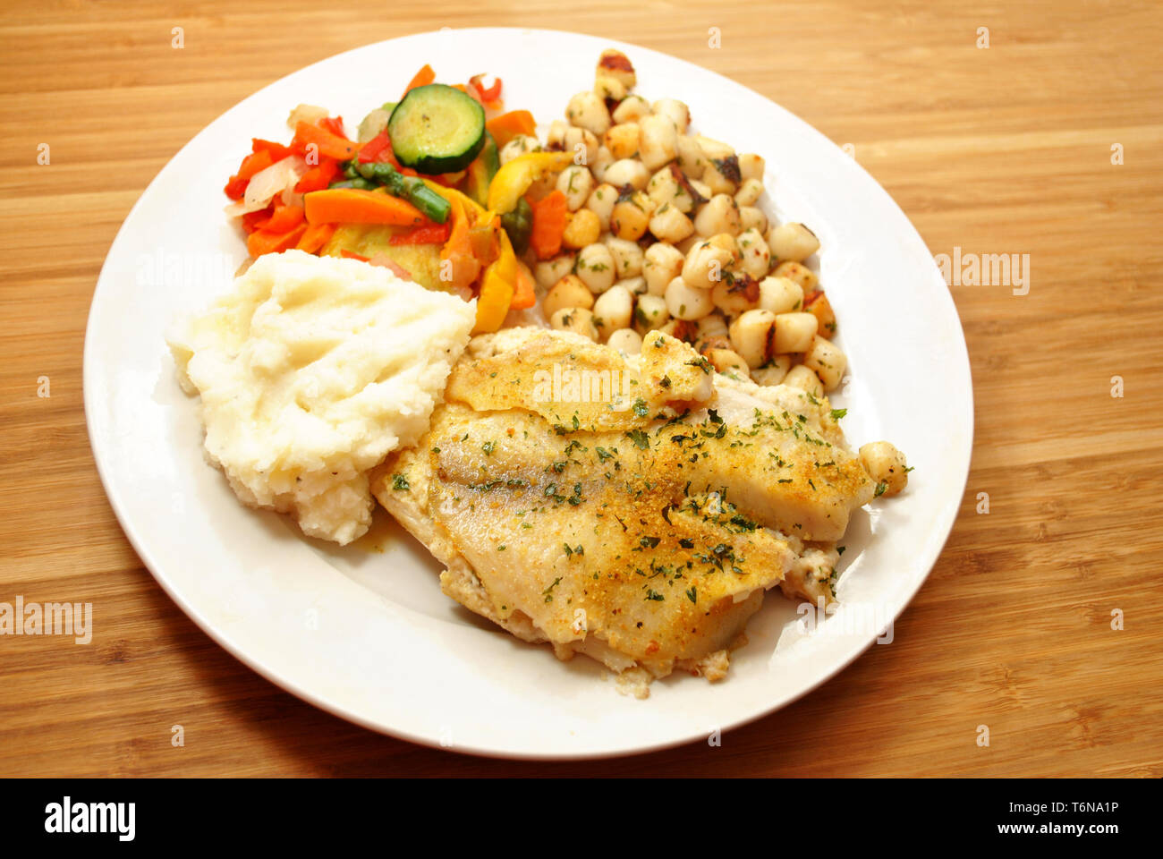 Meal of Fish, Scallops, Mashed Potatoes & Steamed Vegetables Stock