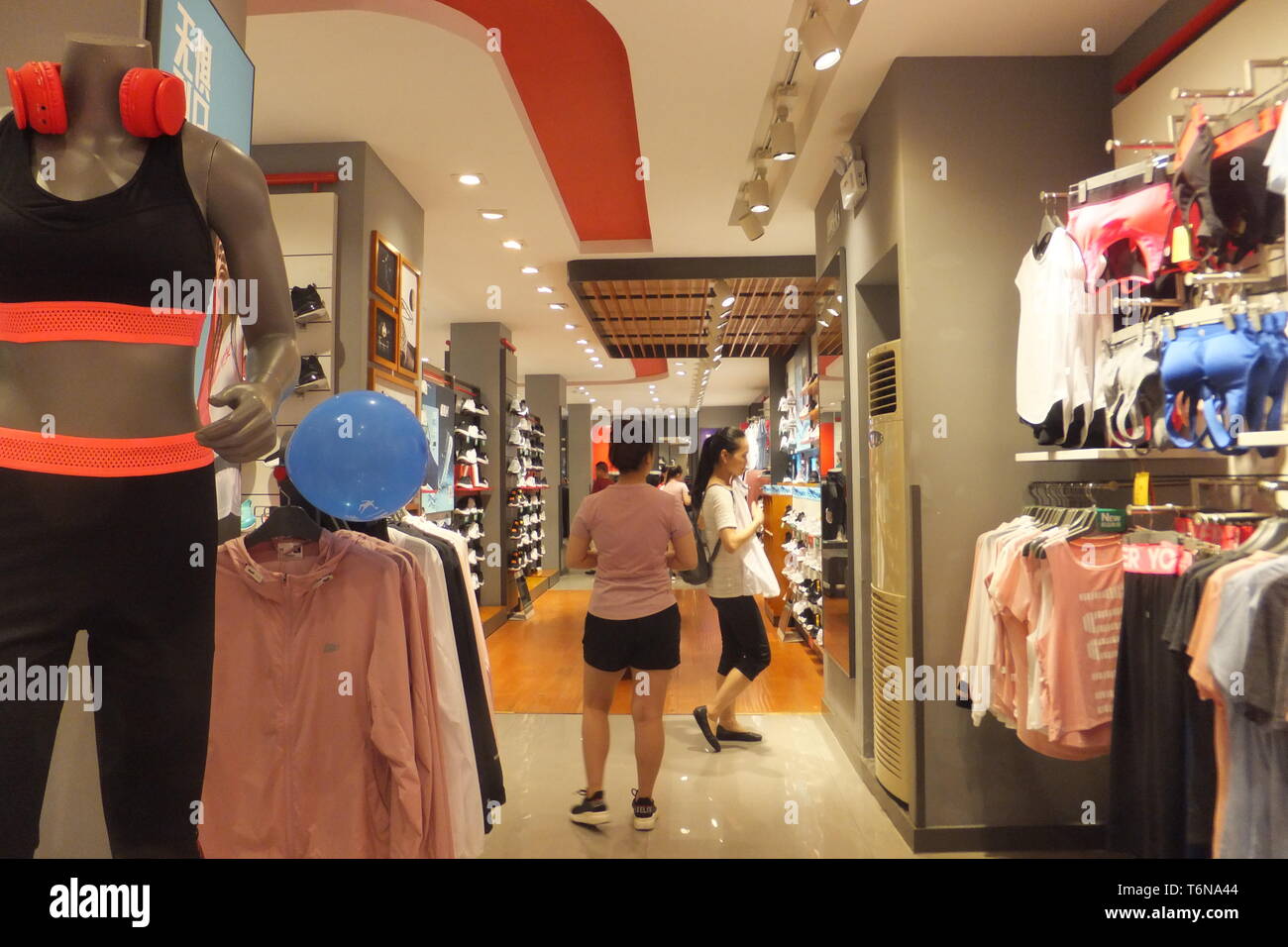 Shenzhen, China: women shop for clothes at qiaodan sports apparel store  interior view Stock Photo - Alamy
