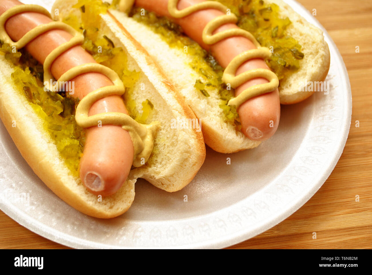 Hot Dogs with Relish and Mustard On a White Plate Stock Photo