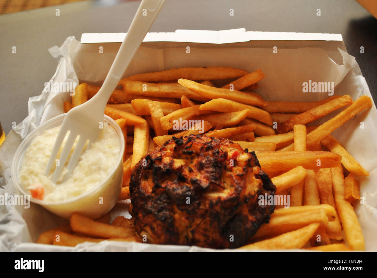 Eating a Crab Cake & French Fries Stock Photo Alamy