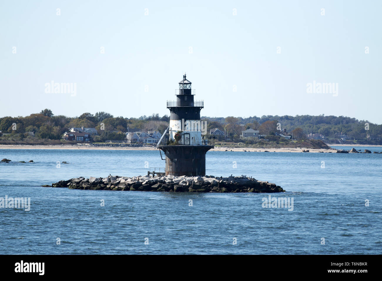 The Orient Point Lighthouse taken from the water. Seaweed is visable on