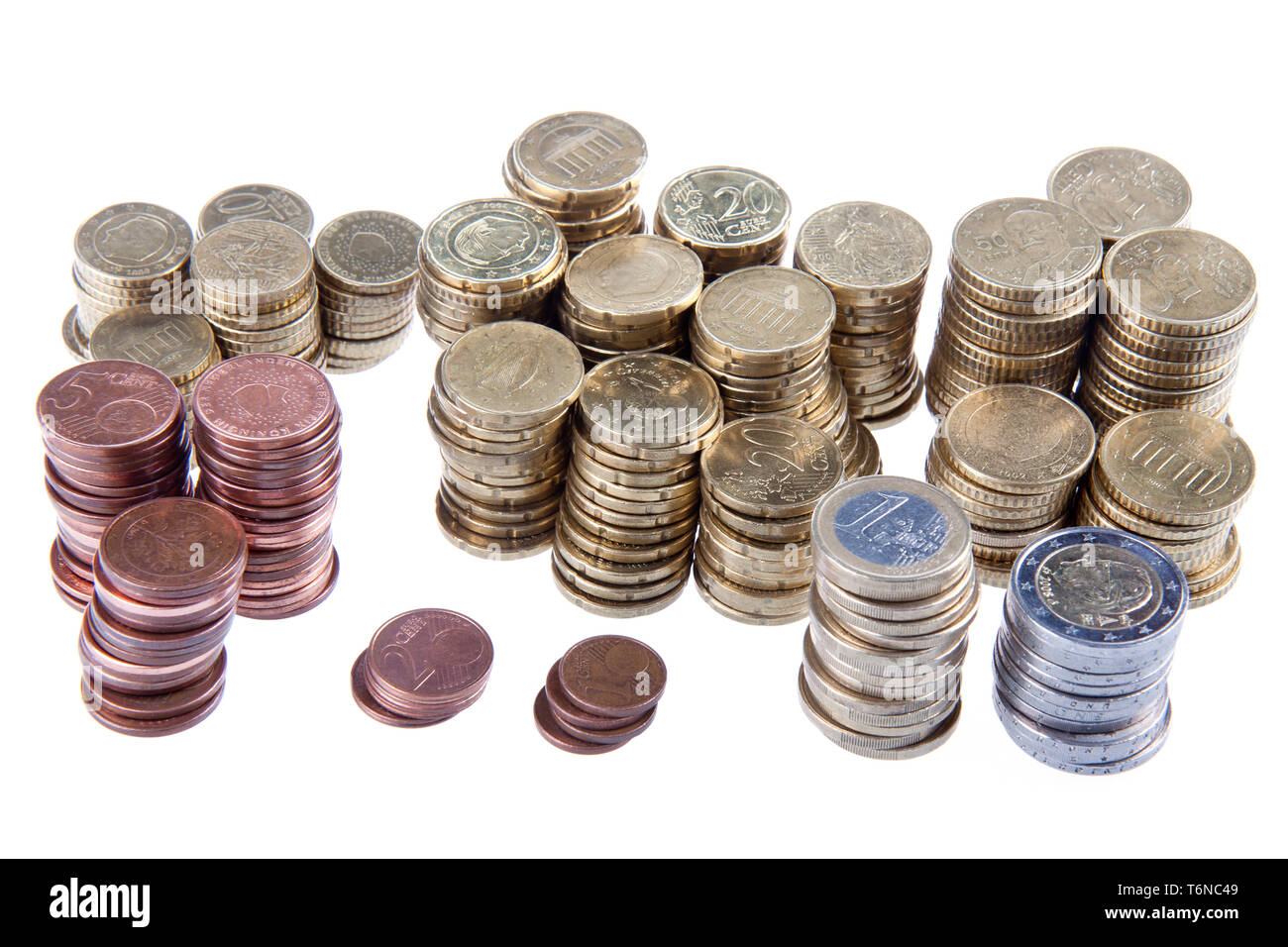 Several piles of european coins on a white background Stock Photo - Alamy