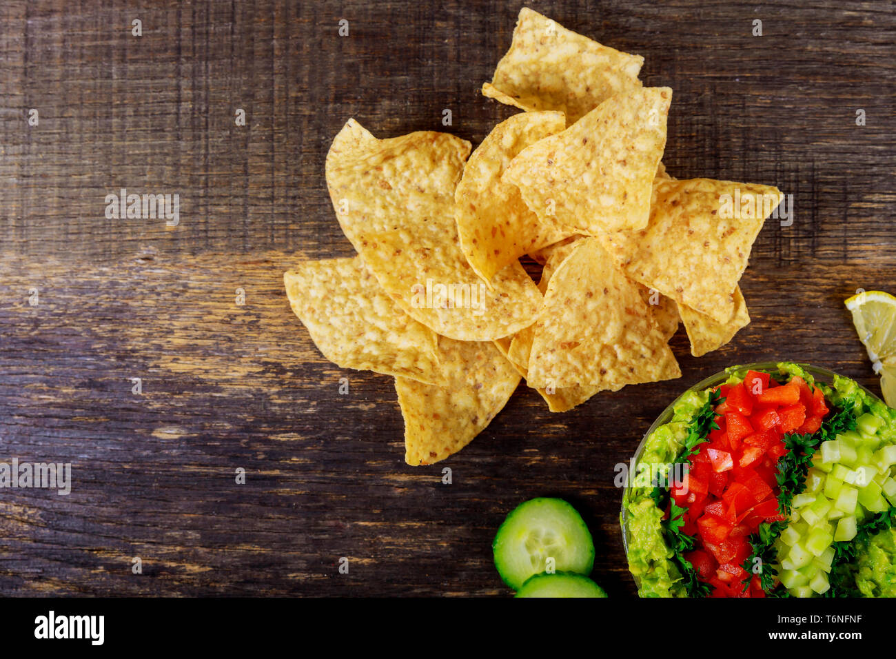 Tortilla chips with avocado dip, tomato and cucumber Stock Photo Alamy