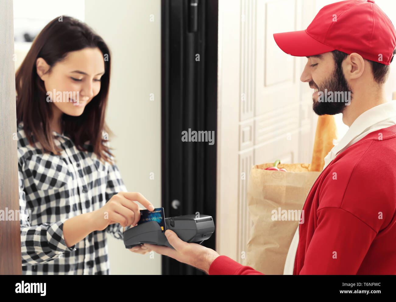 Young woman paying for food delivery with credit card Stock Photo Alamy