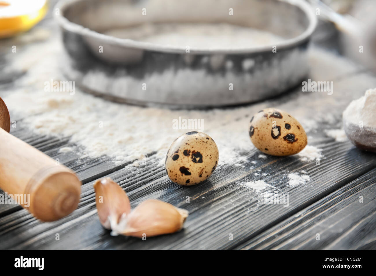 Quail eggs and flour on kitchen table. Bakery workshop Stock Photo - Alamy