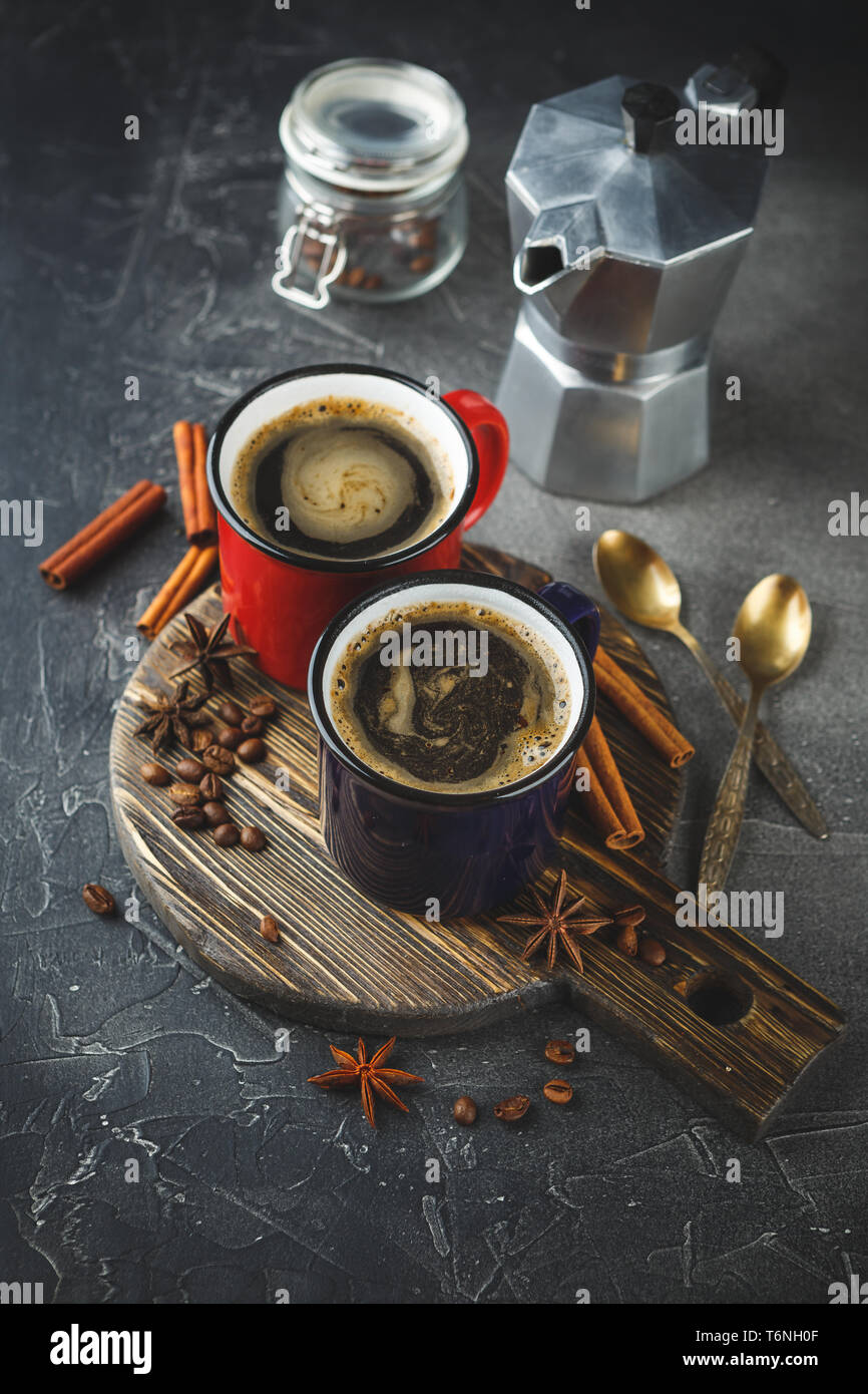 Winter coffee with spices in color enamelled cups Stock Photo