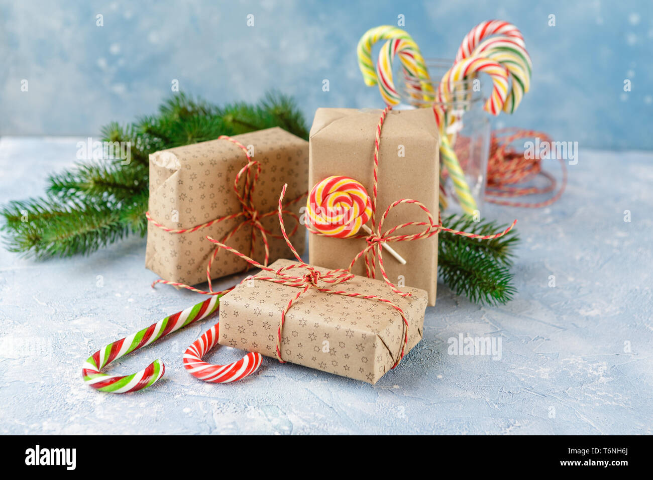 Christmas gift box, candy cane and fir tree branch Stock Photo - Alamy