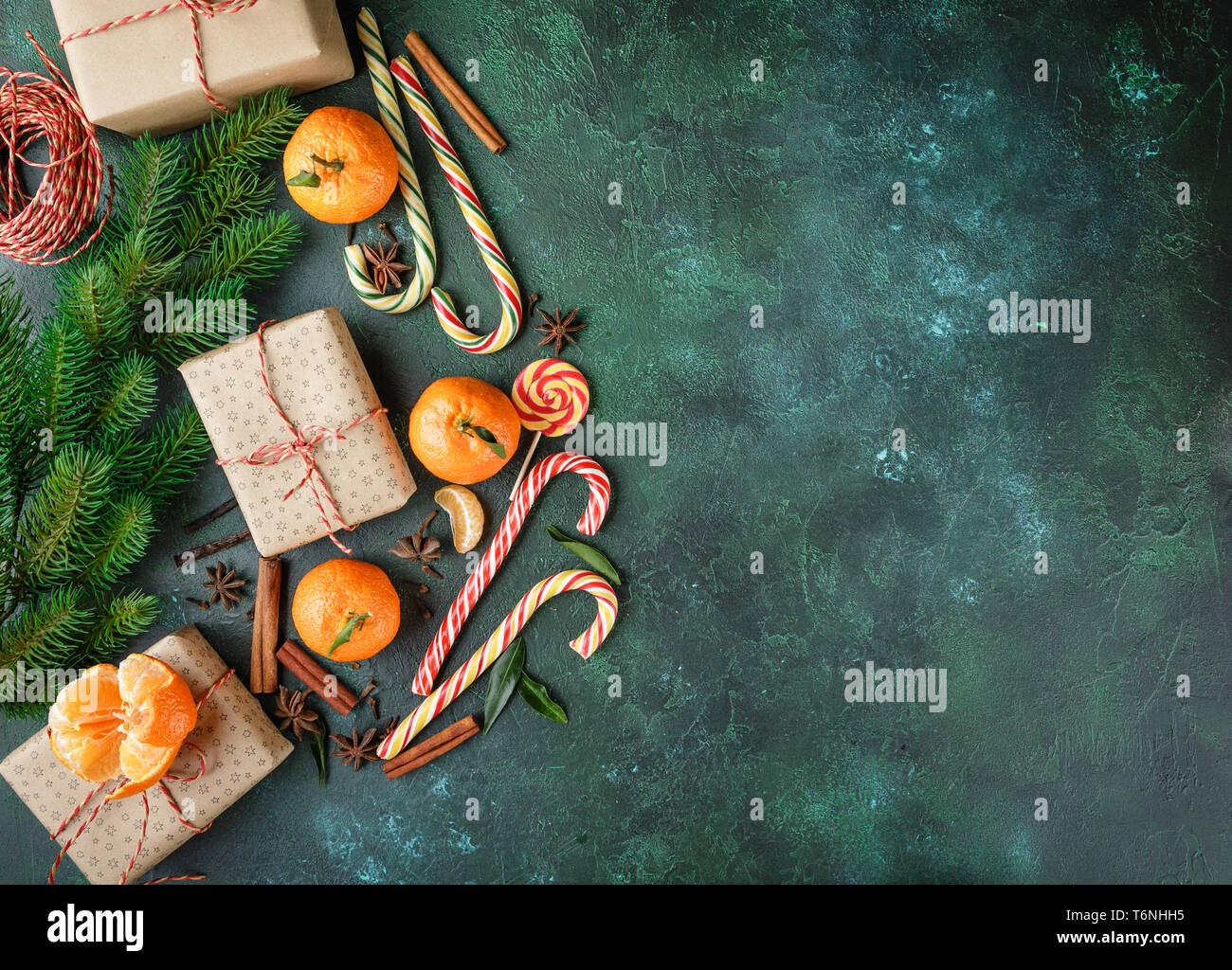 Cinnamon, candy canes and tangerines with leaves Stock Photo - Alamy